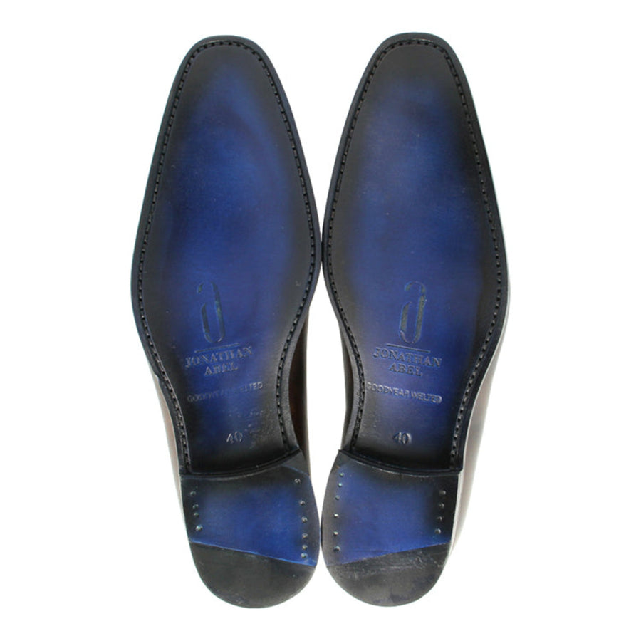 Handmade in Portugal, Alexander's midnight blue Oxford shoes boast meticulous craftsmanship and signature blue soles.